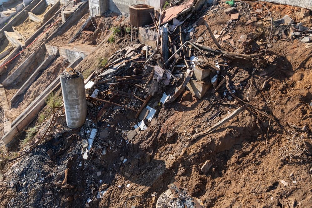 A cleared Palisades parcel stripped to foundations and bare graded earth after debris removal